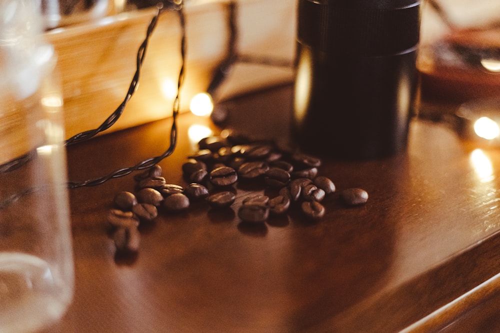 a coffee cup and some coffee beans on a table