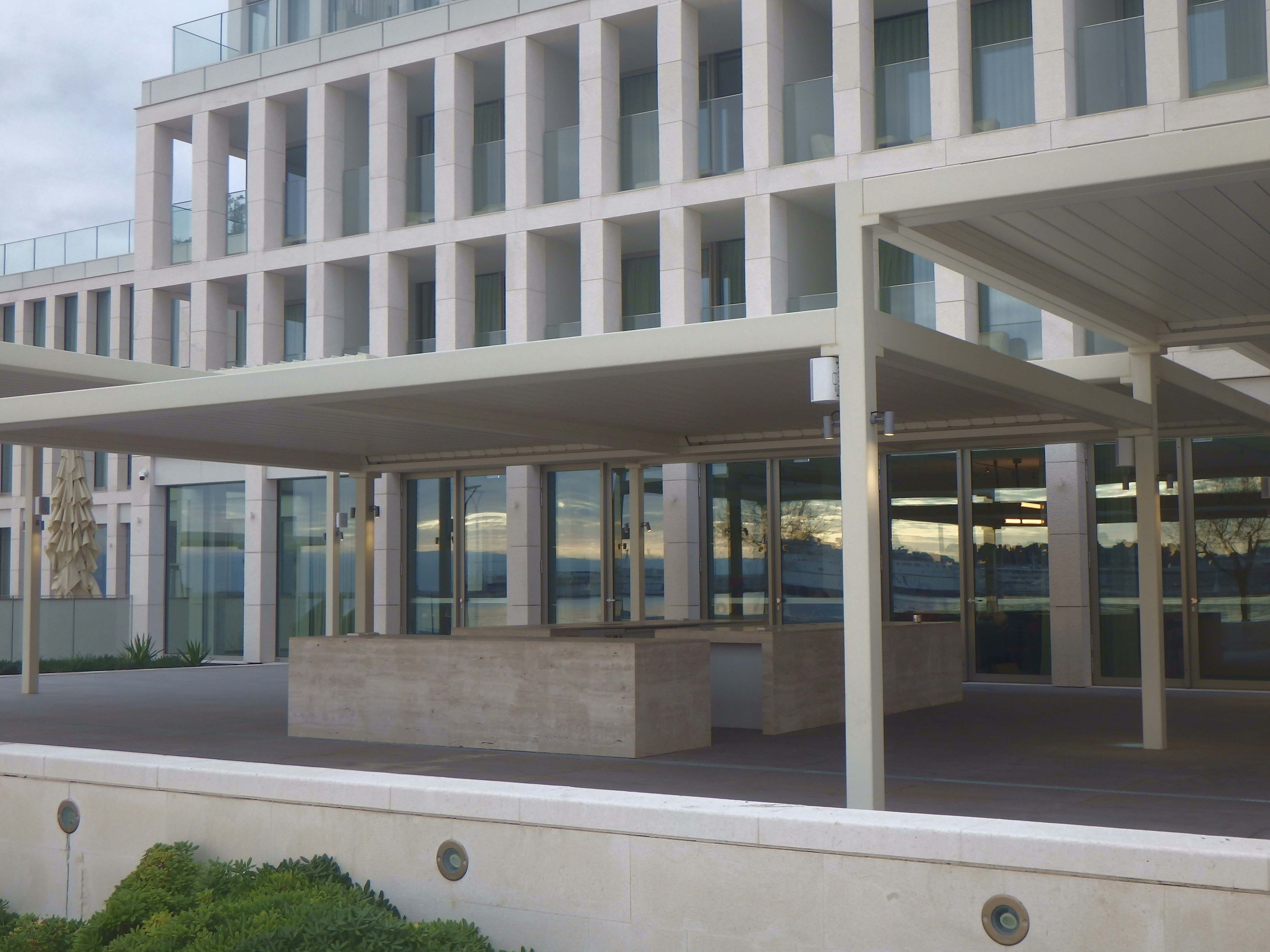 a building with a lot of windows and a bench in front of it