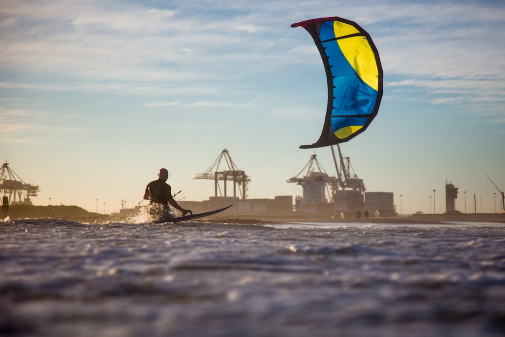 a man riding a kiteboard on top of a body of water