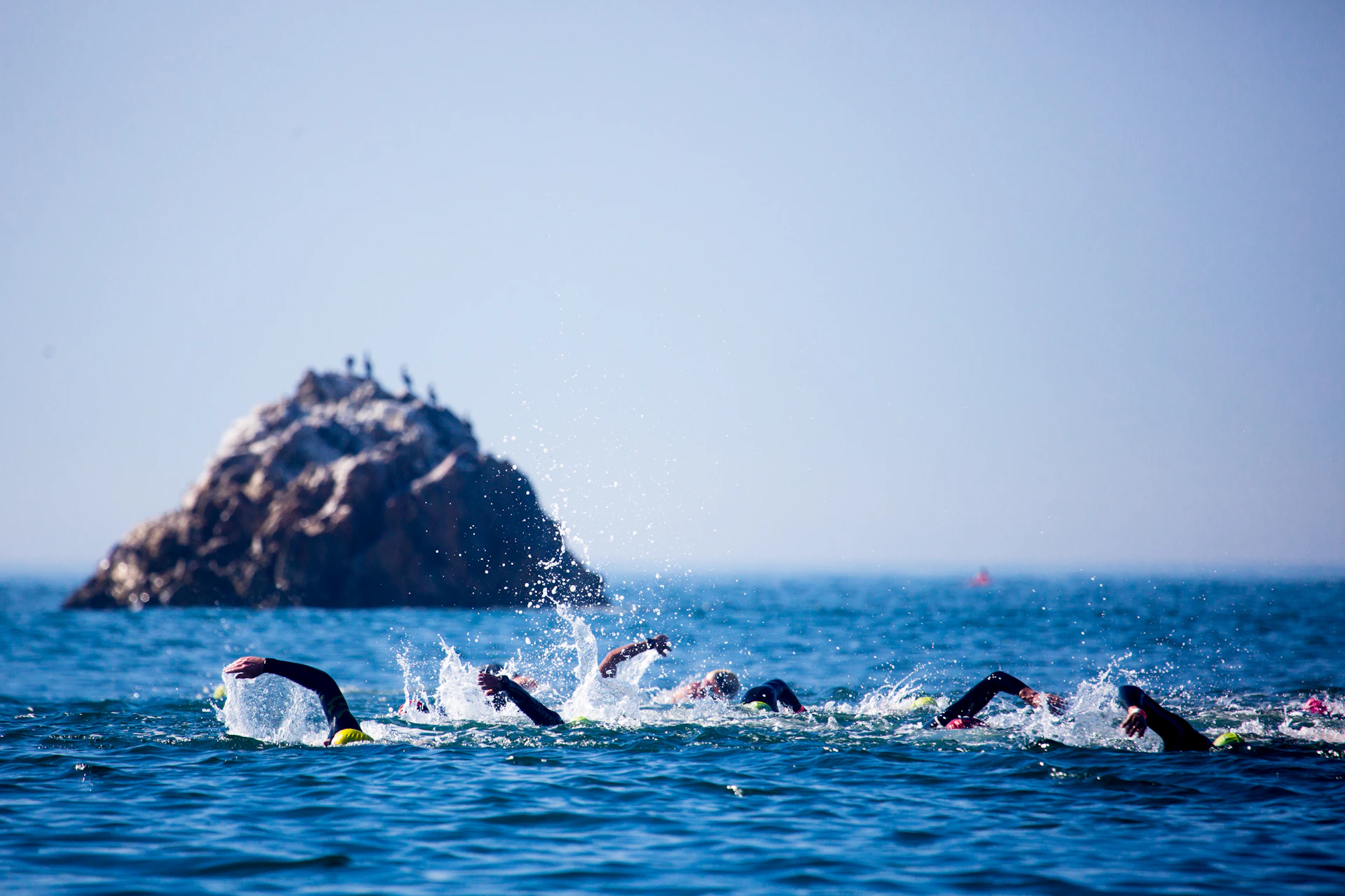 a group of people swimming in the ocean