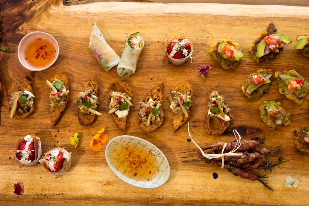 a wooden cutting board topped with lots of food