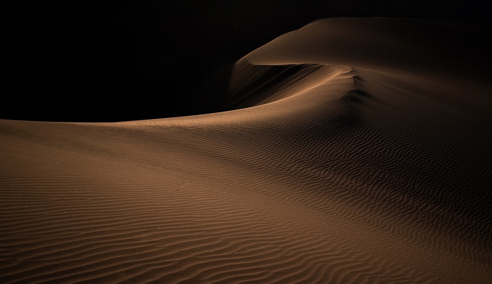 a large sand dune in the middle of a desert