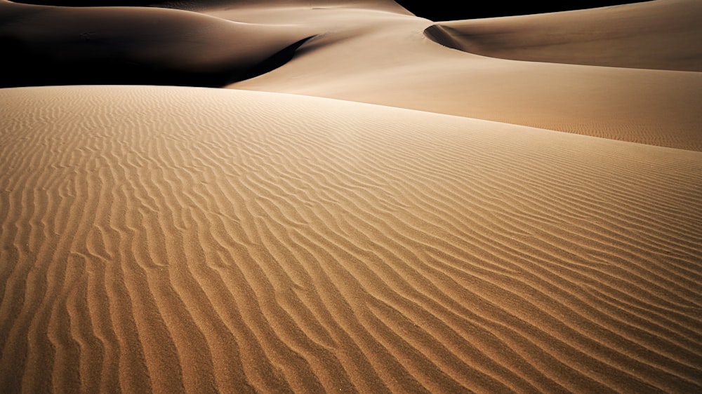 a large sand dune in the middle of a desert