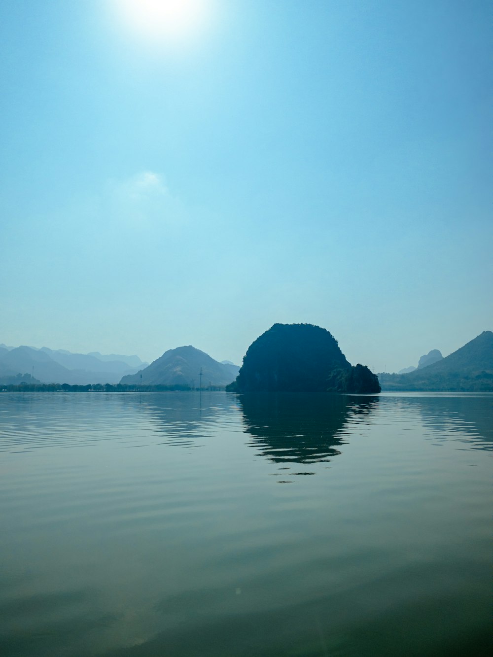 a body of water with a small island in the middle of it