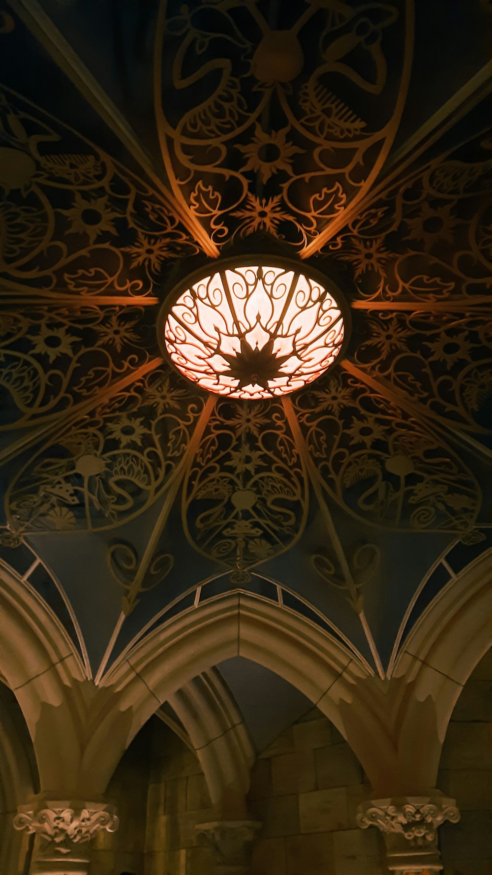 the ceiling of a building with a fancy light fixture