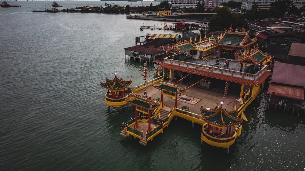 a large yellow boat floating on top of a body of water