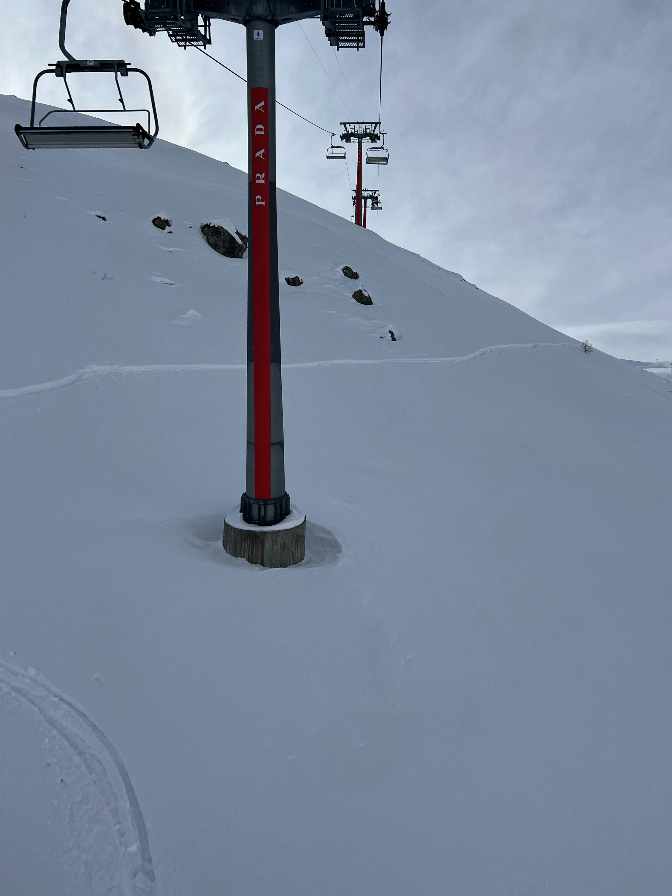 a ski lift going up a snowy mountain