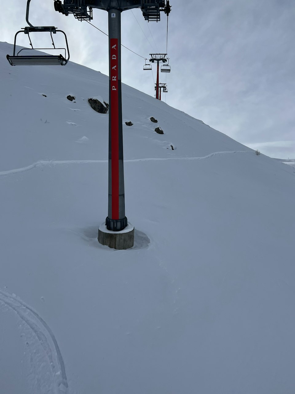 A cable car climbing a snowy mountain slope above St. Moritz, Switzerland
