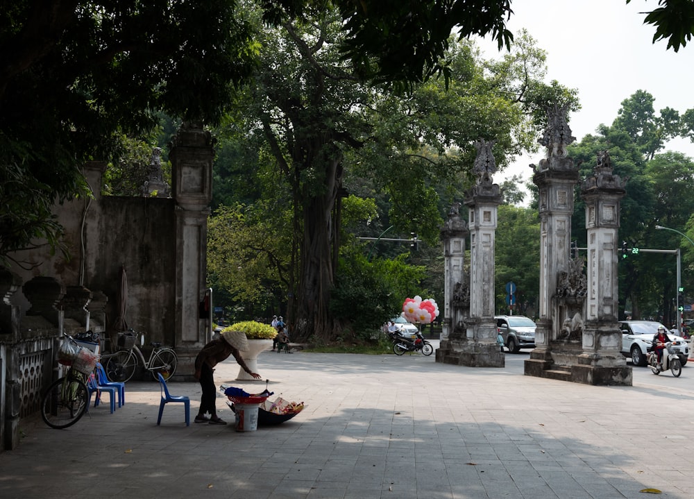 a person sitting on a bench in a park