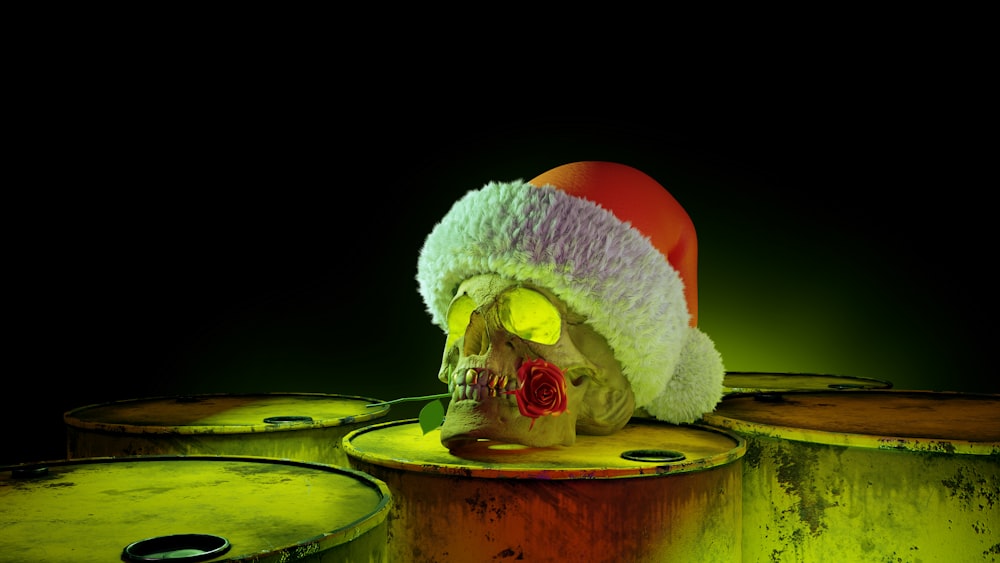 a skull wearing a santa hat sitting on top of barrels
