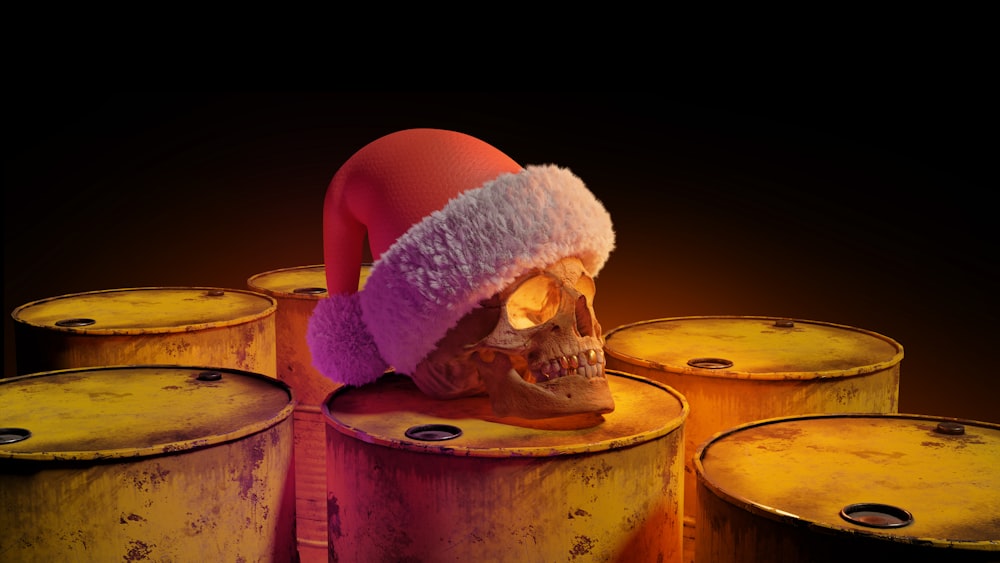 a human skull wearing a santa hat on top of barrels
