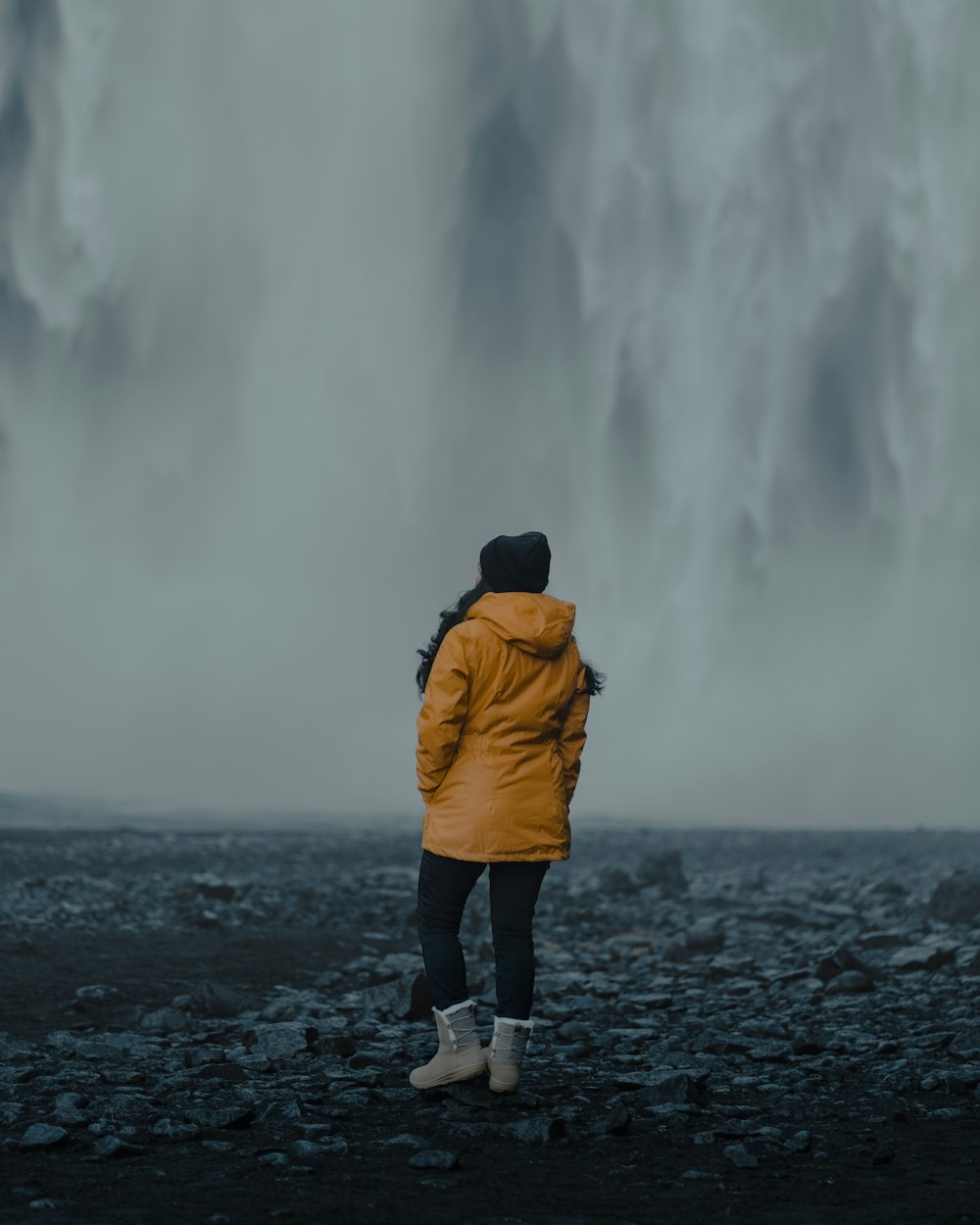 a person standing in front of a waterfall