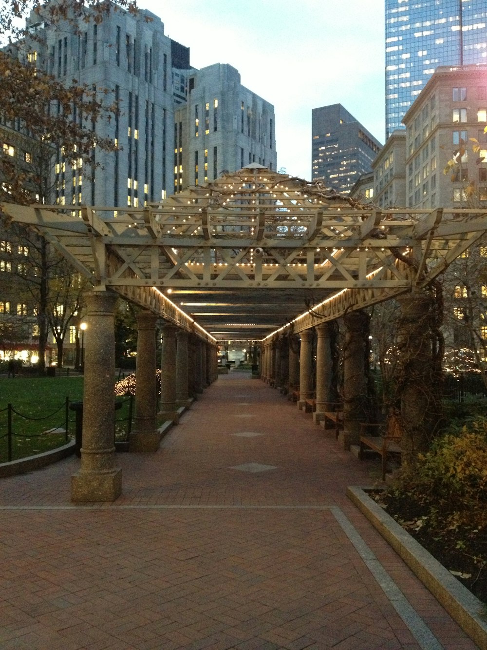 a walkway in a city with a lot of buildings in the background