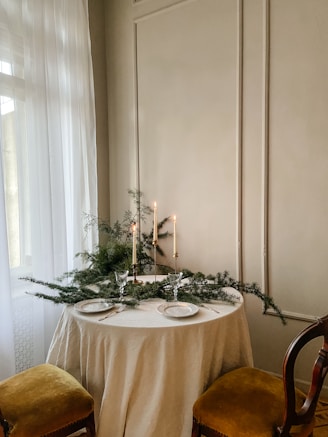 a table with a white table cloth and candles