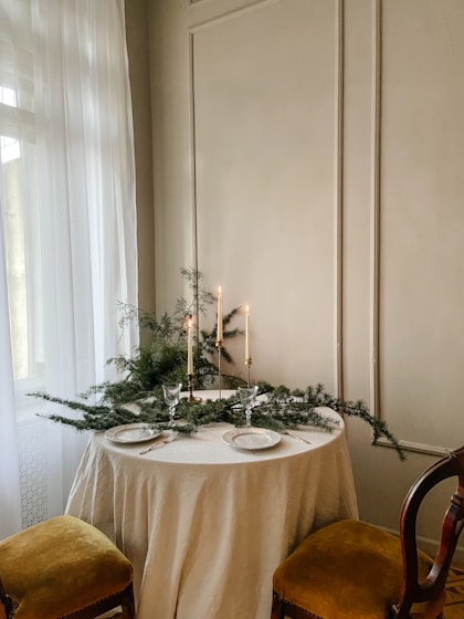 a table with a white table cloth and candles