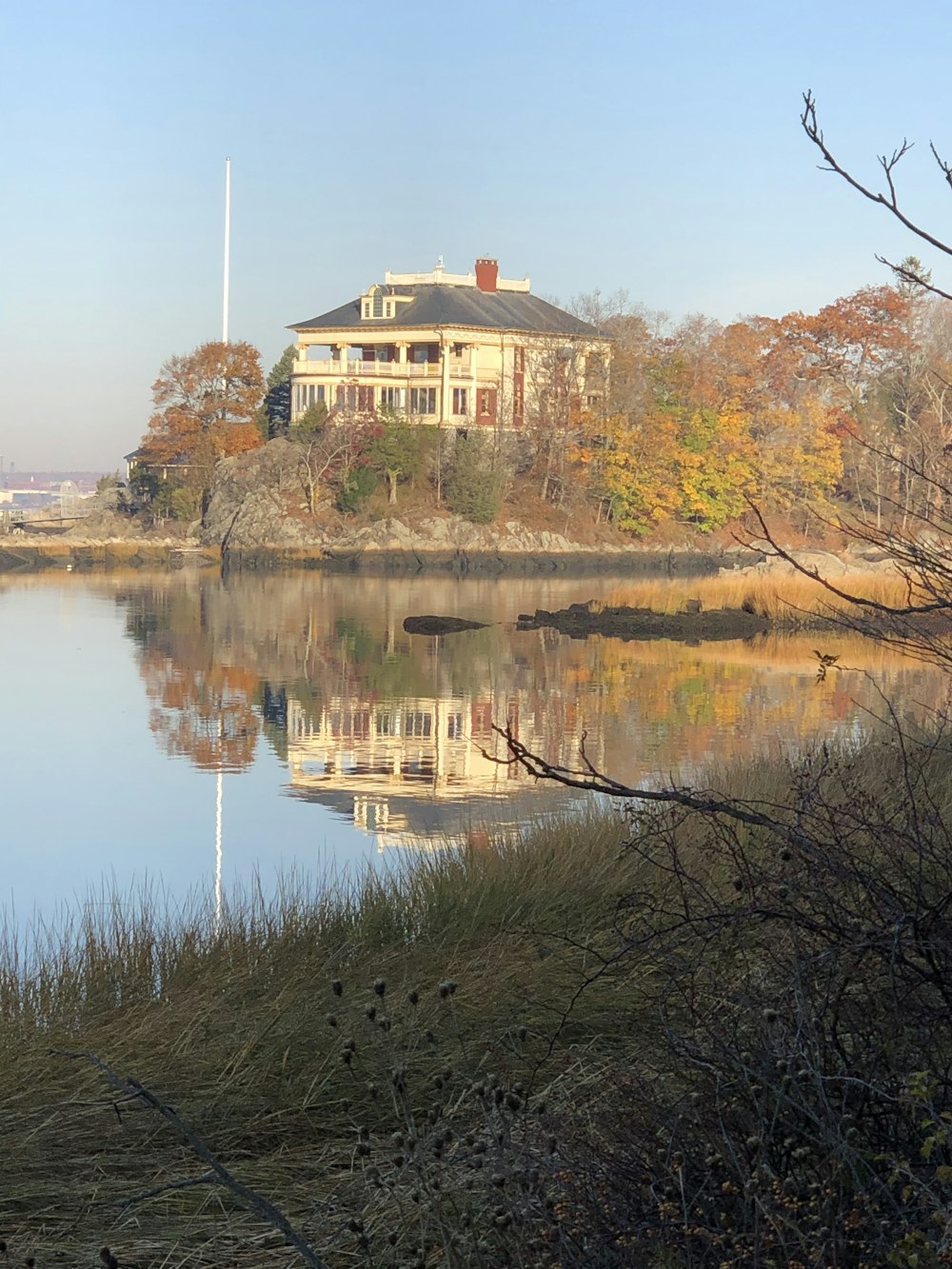 a large white house sitting on top of a lake