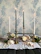Elegant baptism candles arranged on a wooden table with soft natural light.
