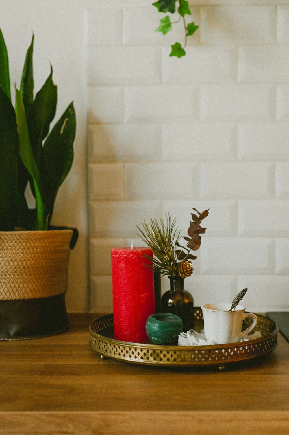 a wooden table topped with a tray filled with candles