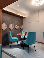 a dining room with blue chairs and a round table