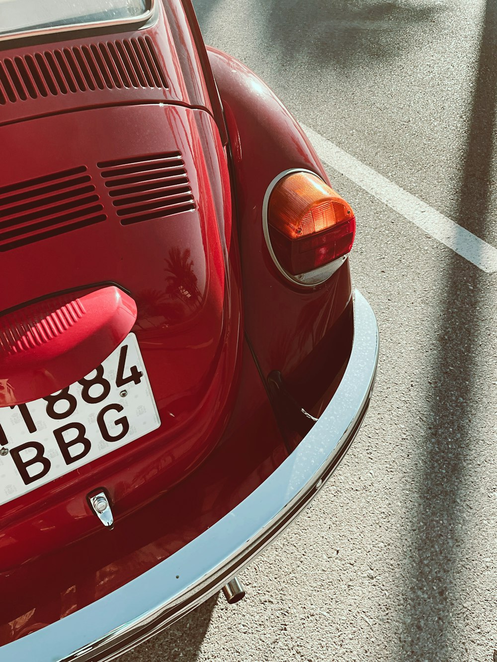 a close up of a red car with a license plate