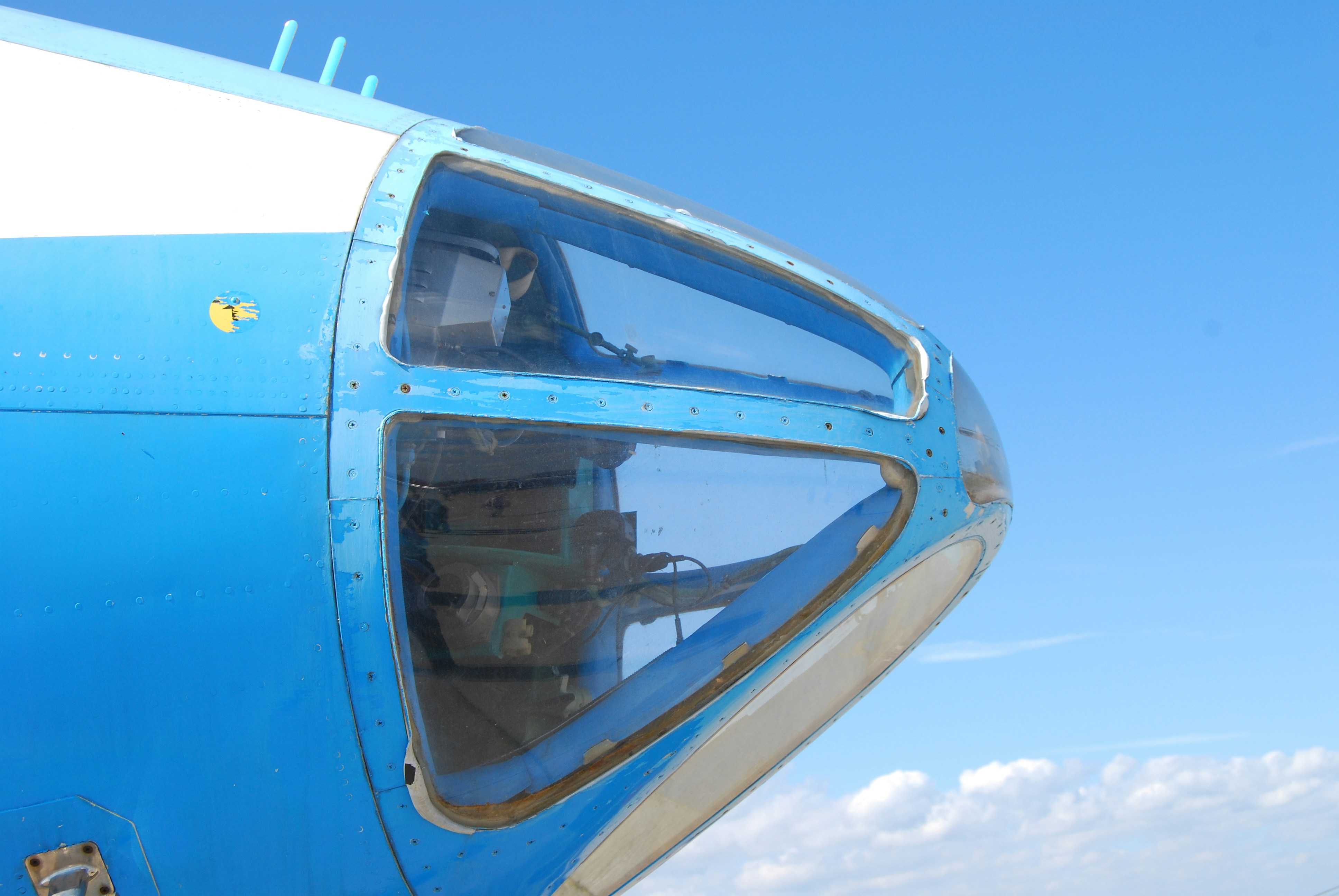 A close up of the side of a blue and white airplane