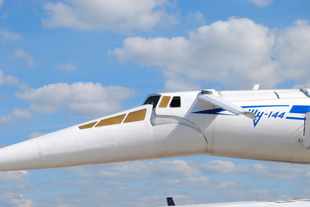 a white and blue airplane is flying in the sky,
