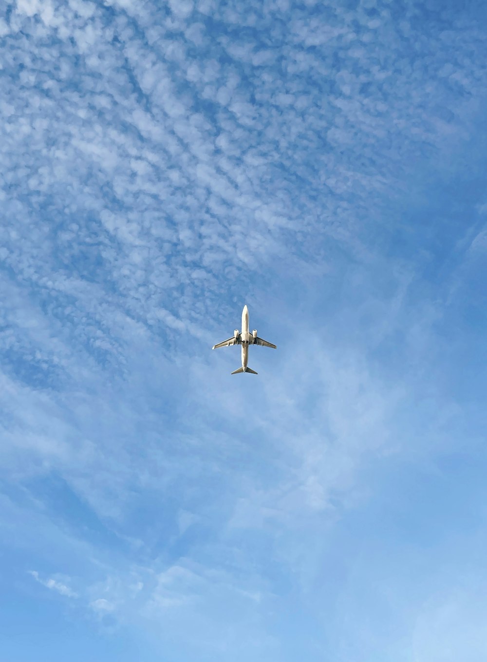 an airplane is flying through the blue sky