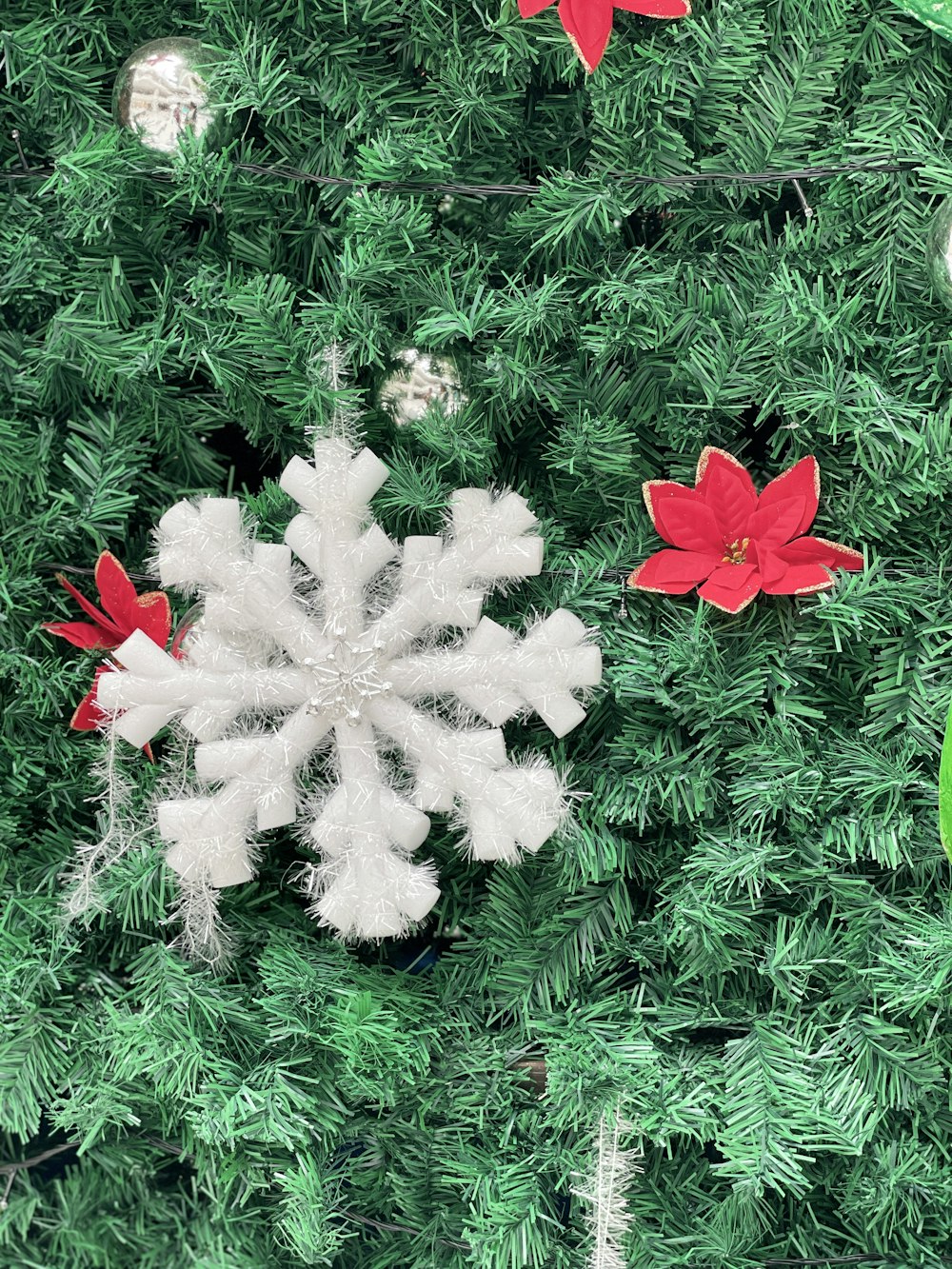 a close up of a snowflake on a christmas tree