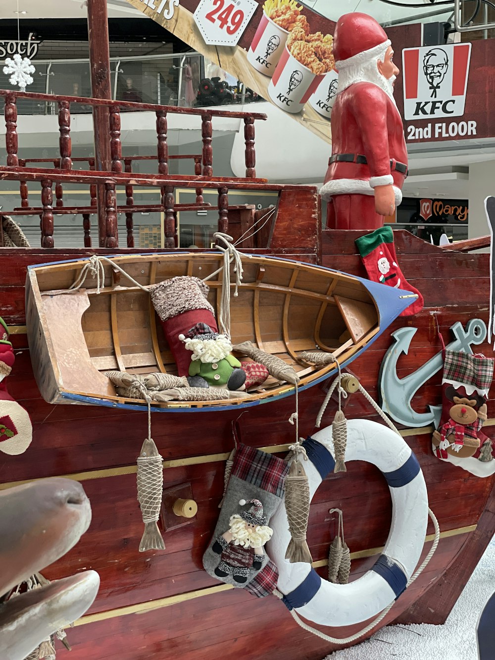a wooden boat with a santa clause on top of it