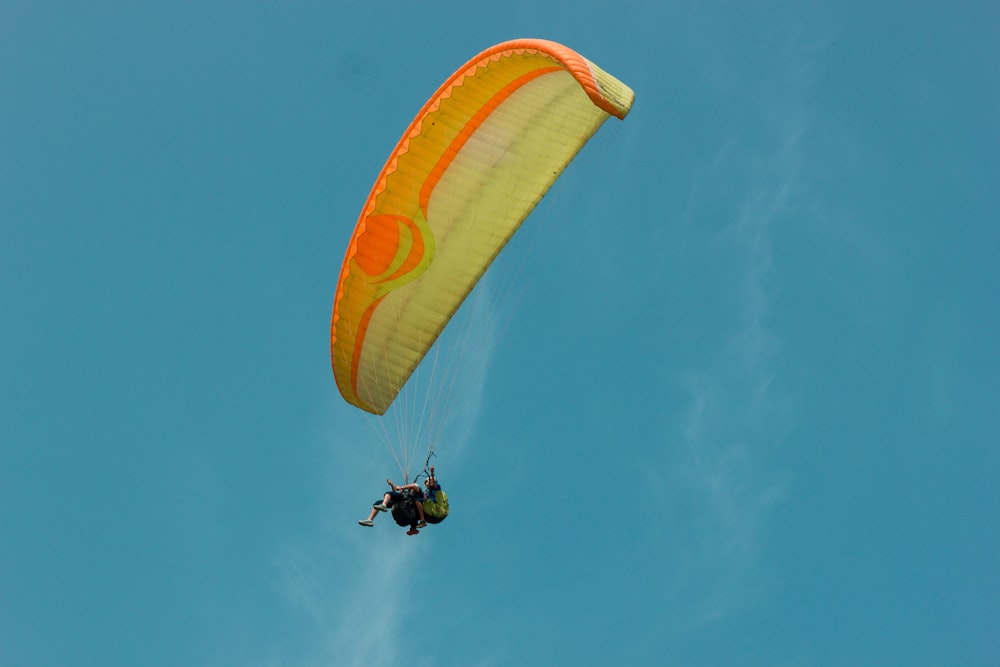 a person is parasailing in the blue sky