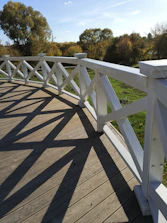 Wide shot of a clean wooden deck after pressure washing on a sunny day.