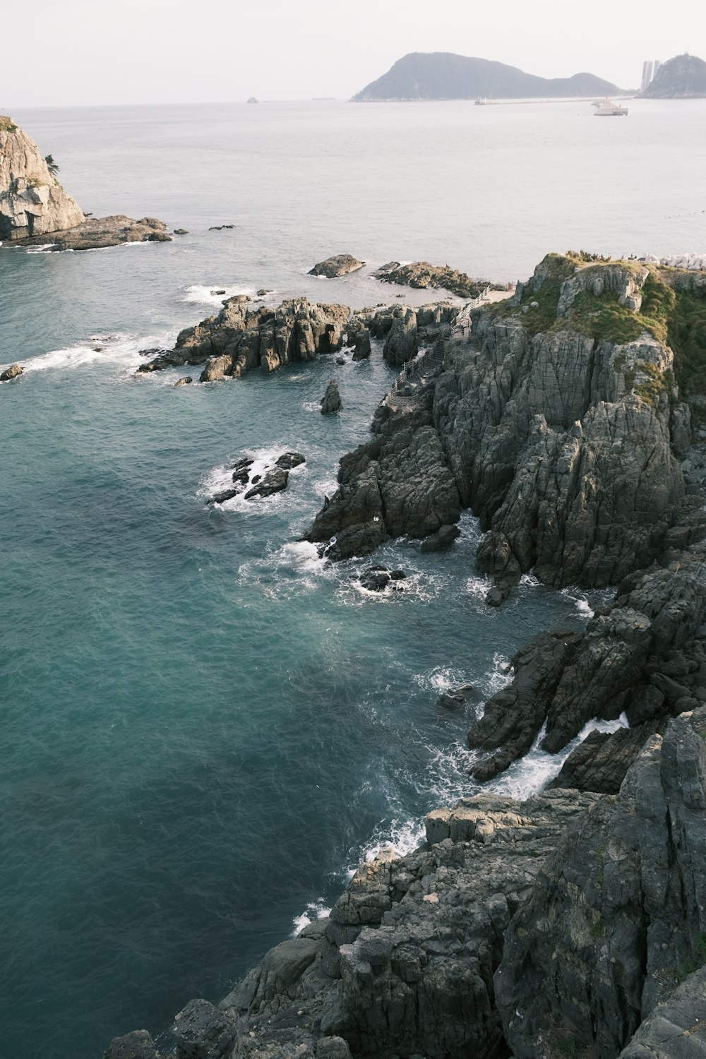 a large body of water next to a rocky shore