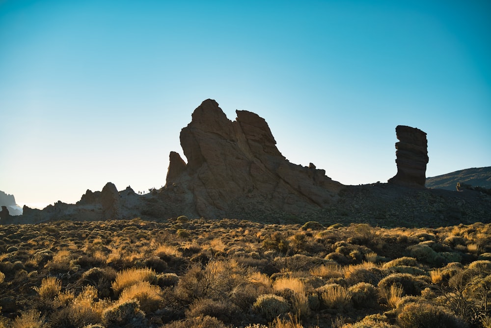 a large rock formation in the middle of a desert