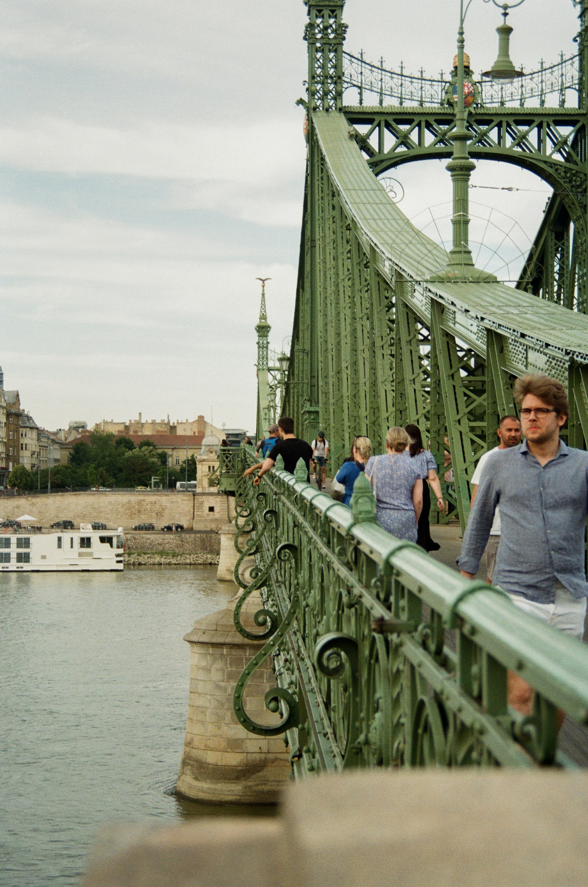 A group of people walking across a bridge photo – Free Car Image on ...