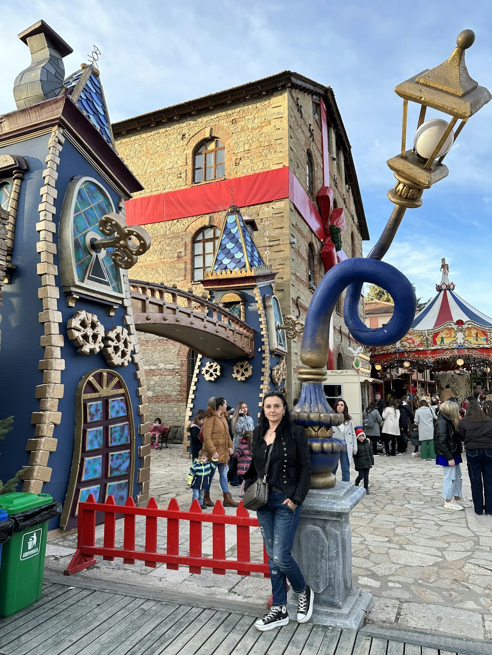 a woman standing in front of a colorful building