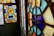 Colorful stained glass windows featuring intricate geometric patterns with vibrant hues of blue, orange, and yellow.