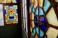 Colorful stained glass windows featuring intricate geometric patterns with vibrant hues of blue, orange, and yellow.