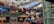 A multi-level shopping mall decorated festively with red and gold reindeer and stars hanging from the ceiling. Various shop fronts, such as Puma, Shree Balaji Diamond, and others, are visible. People are shopping and walking along the balconies. There are advertisements for Budweiser and LG.