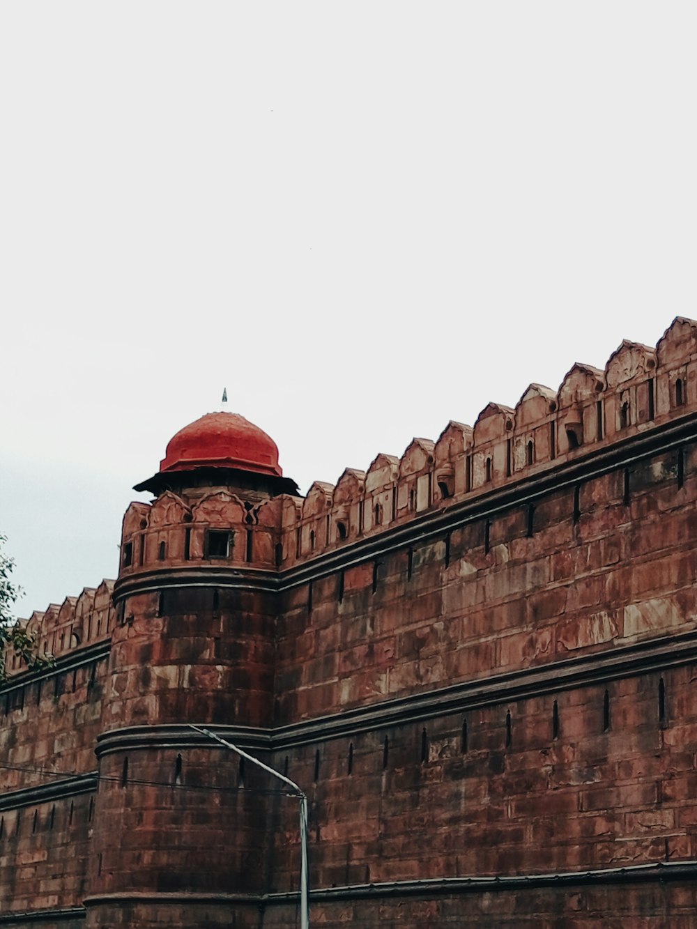 a large brick building with a red dome on top