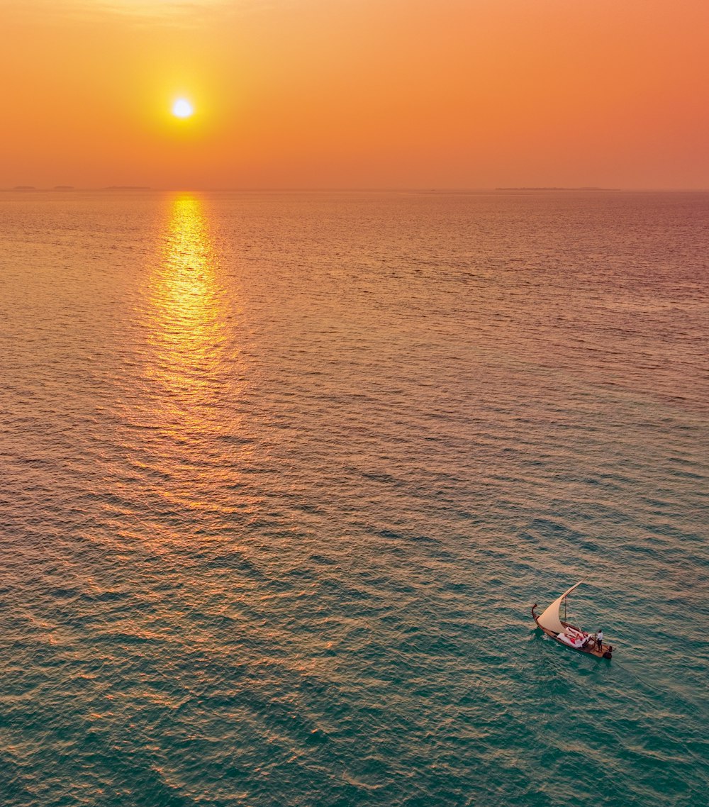 a small boat floating on top of a large body of water