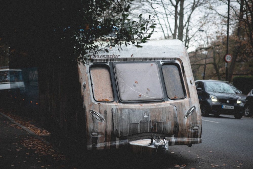 an old bus is parked on the side of the road