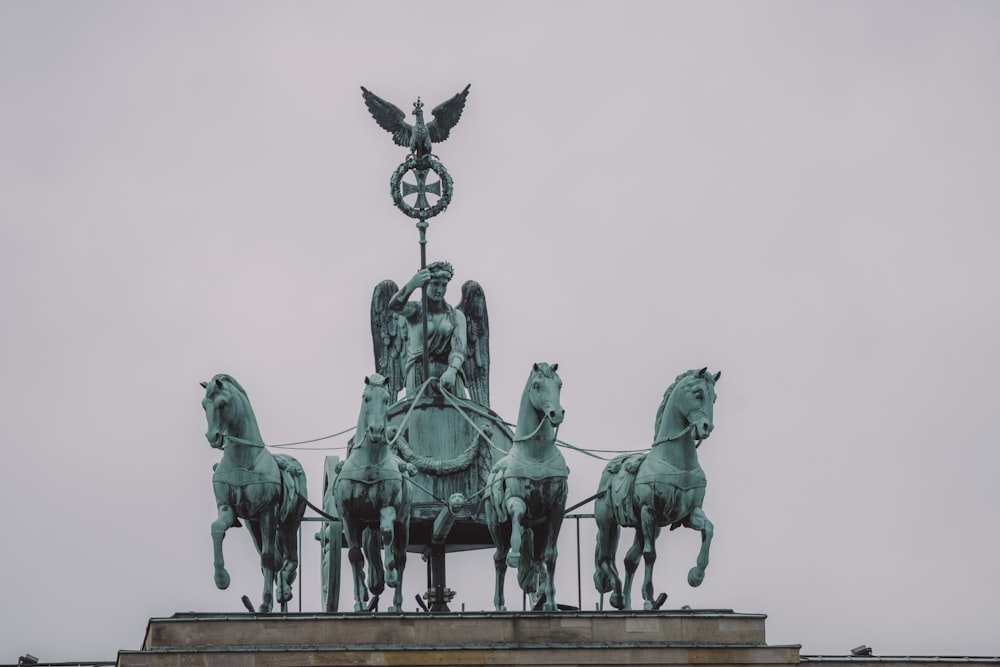 a statue of a man on a horse with a bird on top of it