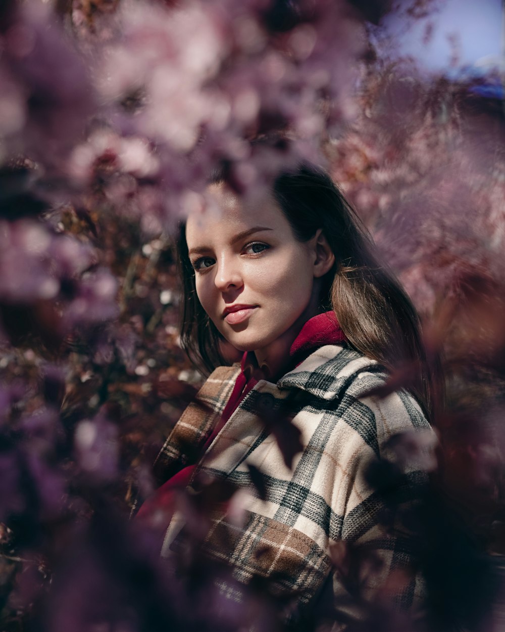 a woman standing in a field of flowers