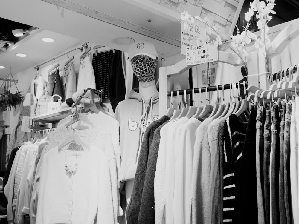 a man standing in front of a rack of clothes