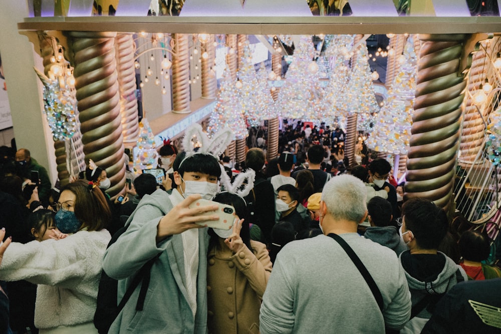 a crowd of people standing around a building