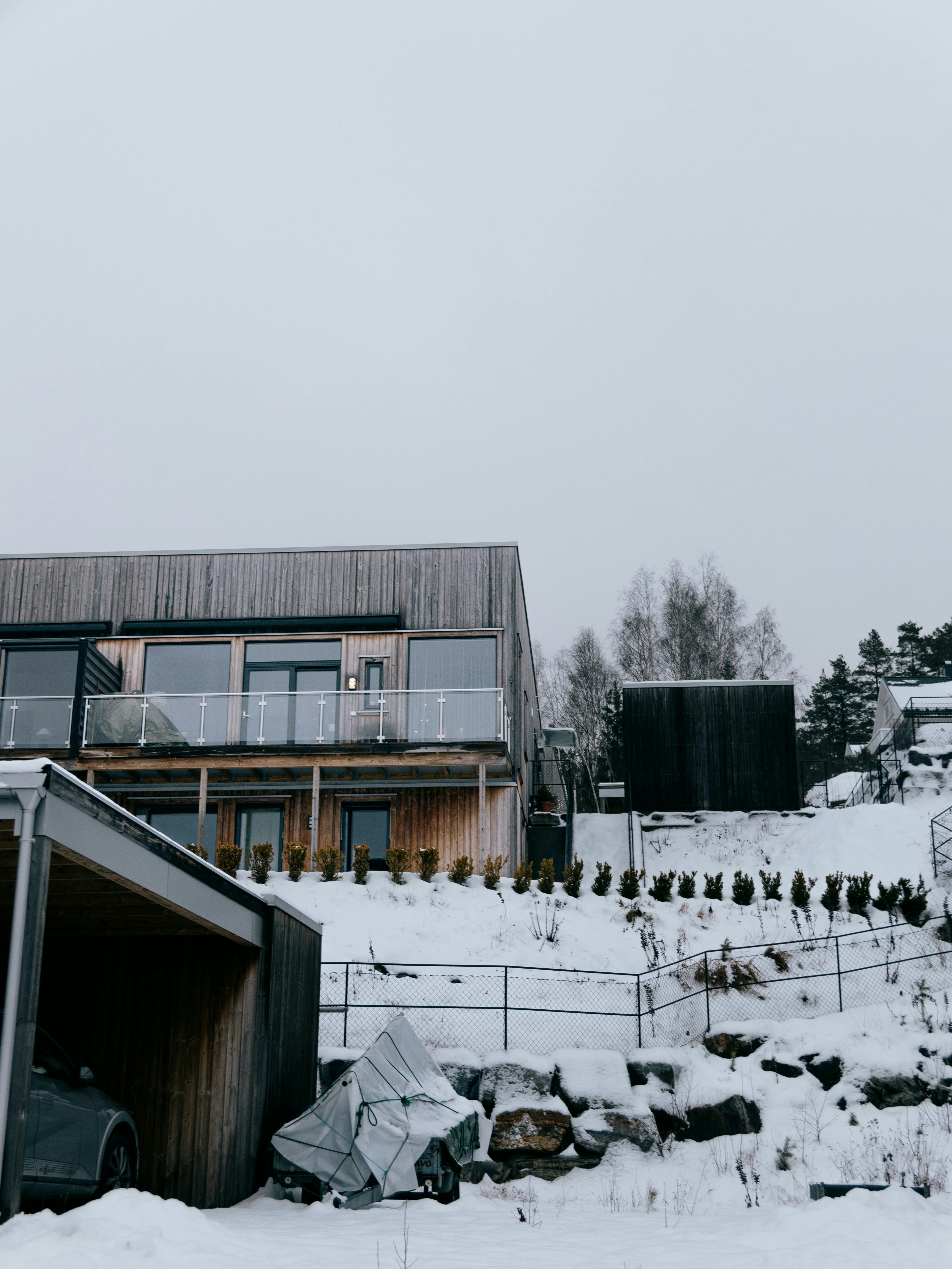a snow covered yard with a house in the background
