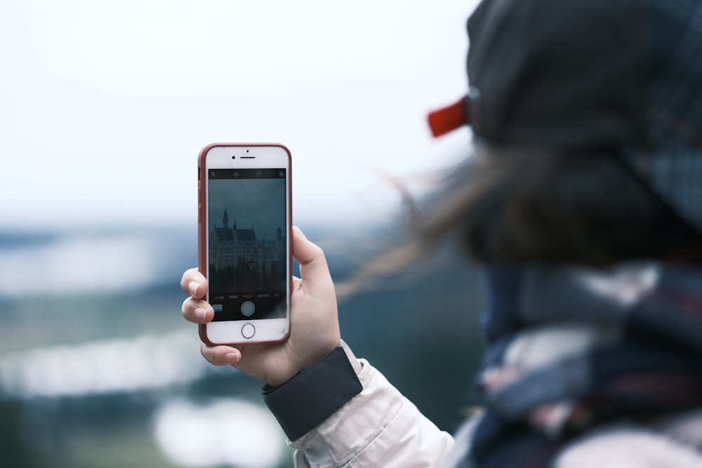 a person taking a picture with a cell phone