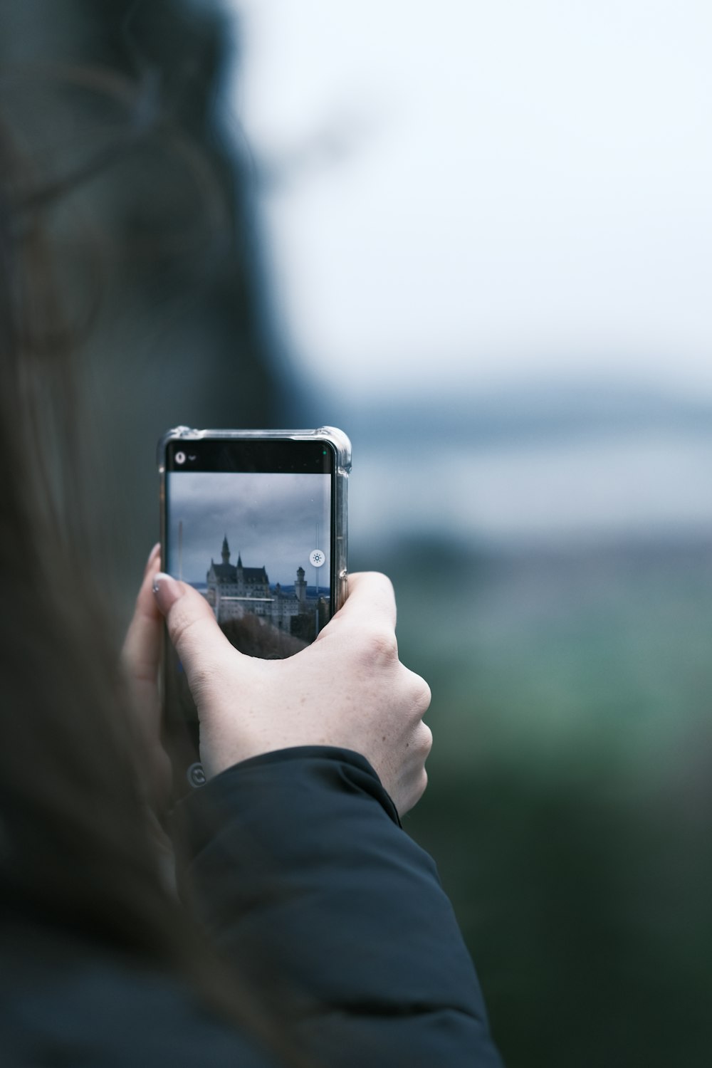 a person taking a picture of a building with a cell phone