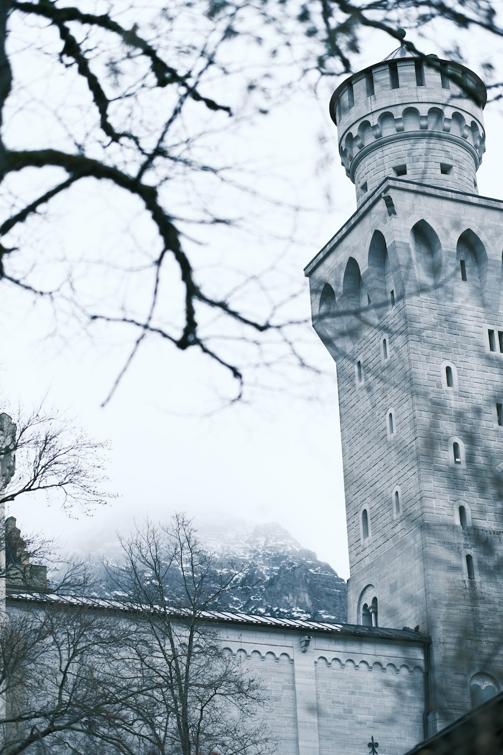 a tall white tower with a clock on it's side