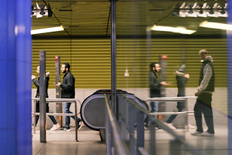 a group of people standing outside of a train station